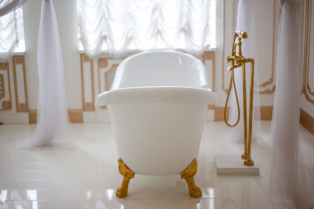 Claw foot tub with gold fixtures